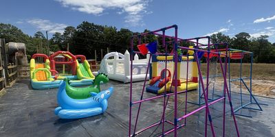 Grasshopper Farms Splash Park in Knightdale offering inflatable water slides, playgrounds, farm animals, and summer fun.
